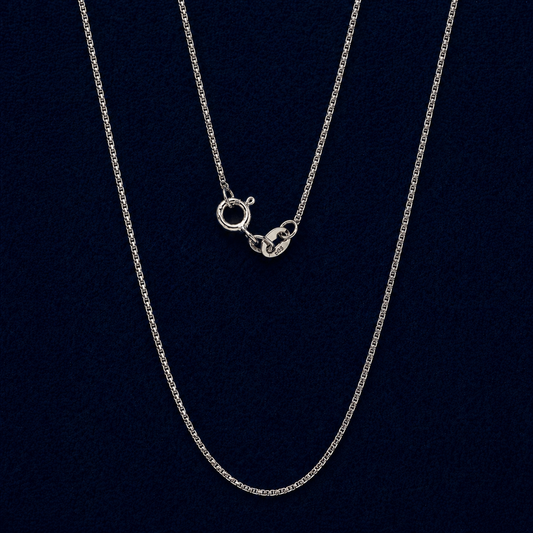 A full view of the handcrafted 925 sterling silver Gridline Chain, featuring delicate small square-shaped links and a neat, structured design against a dark navy background.