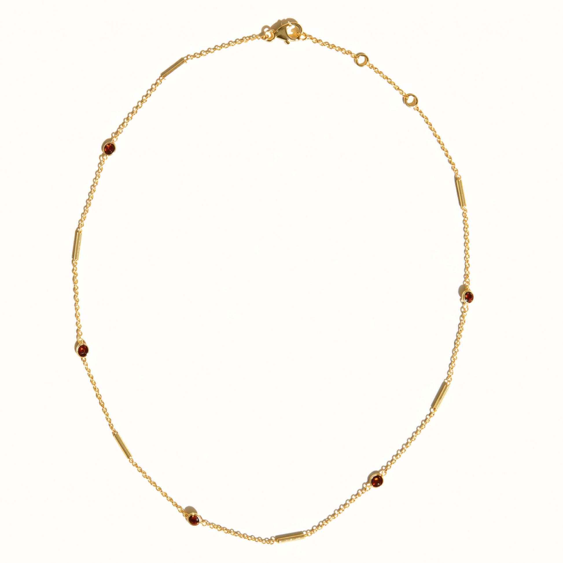 A full studio shot of the Warm Glow Necklace on a neutral background, displaying the linear stone and bar design with the adjustable lobster clasp closure.