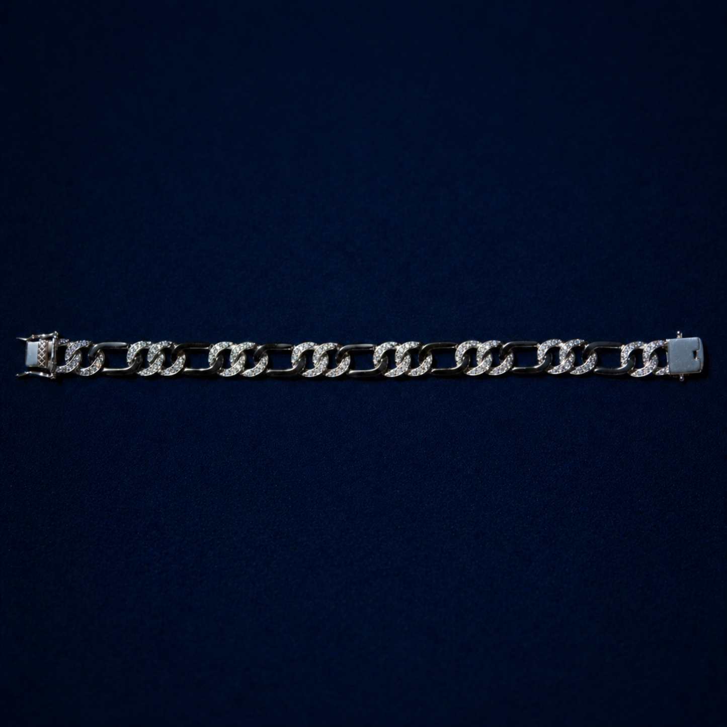 A top-down view of Effortless Edge bracelet on a dark navy background, displaying the rhythmic architectural design.