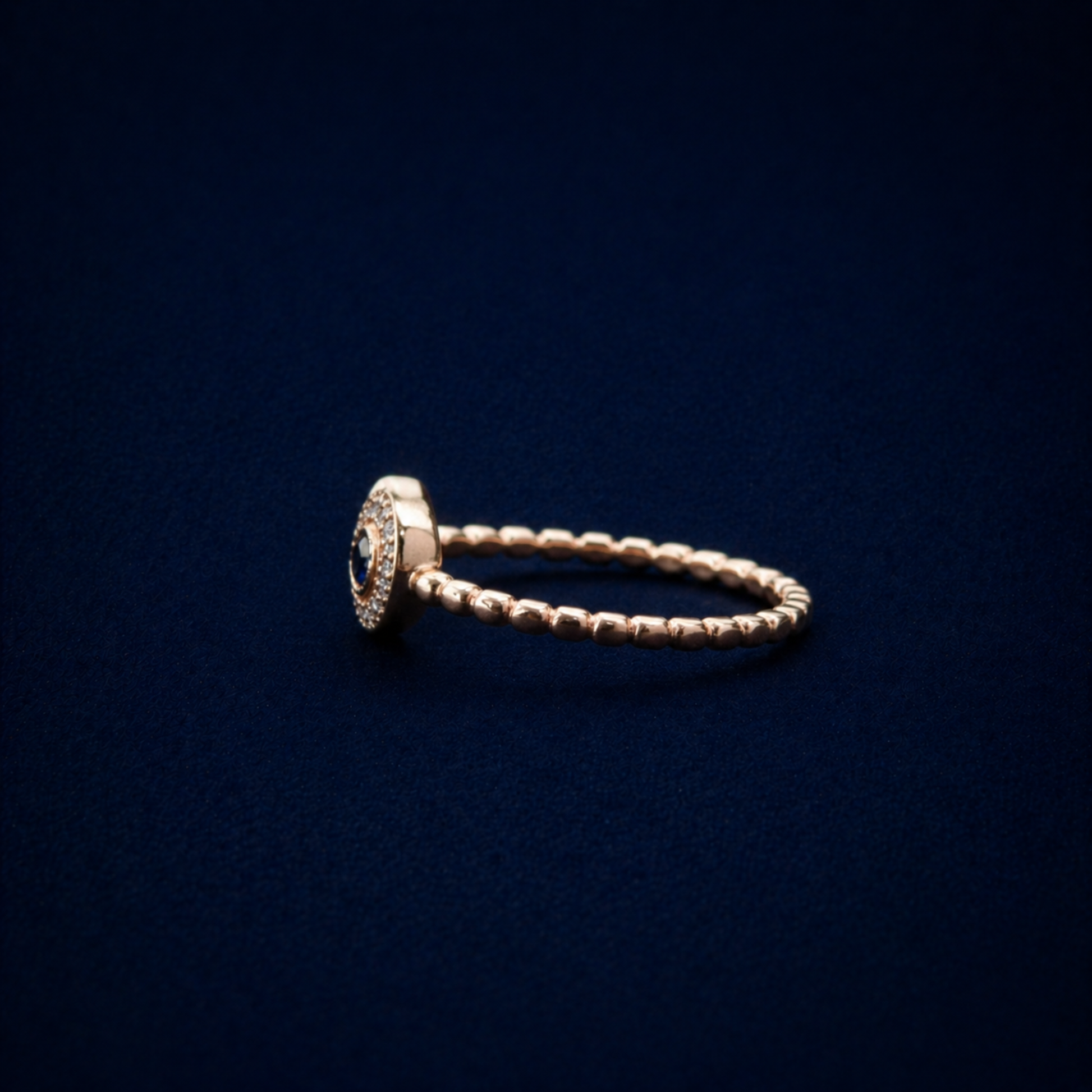 Side profile of the A Little Love Ring showcasing the delicate beaded texture of the adjustable band and the raised heart-shaped cubic zirconia setting.