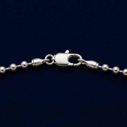 A detailed close-up of the Everyday Soft Glow necklace highlighting the substantial weight, the polished silver bead texture, and the secure lobster clasp closure.