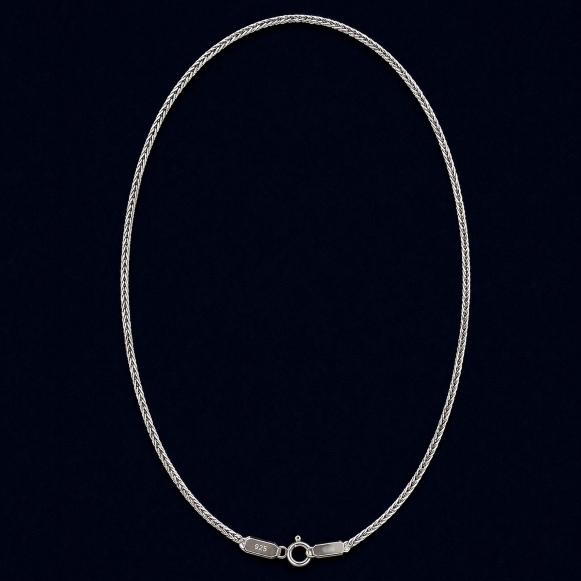 A full view of the handcrafted Infinite Link chain in 925 sterling silver, featuring a fluid interlocking design in an elegant oval layout against a dark navy background.