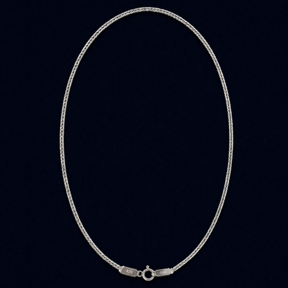 A full view of the handcrafted Infinite Link chain in 925 sterling silver, featuring a fluid interlocking design in an elegant oval layout against a dark navy background.