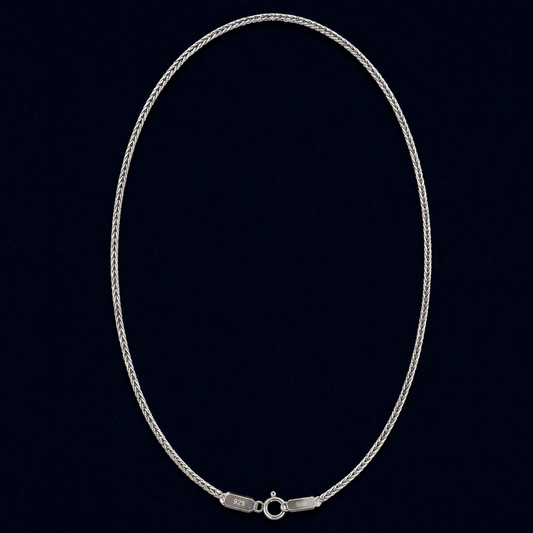 A full view of the handcrafted Infinite Link chain in 925 sterling silver, featuring a fluid interlocking design in an elegant oval layout against a dark navy background.