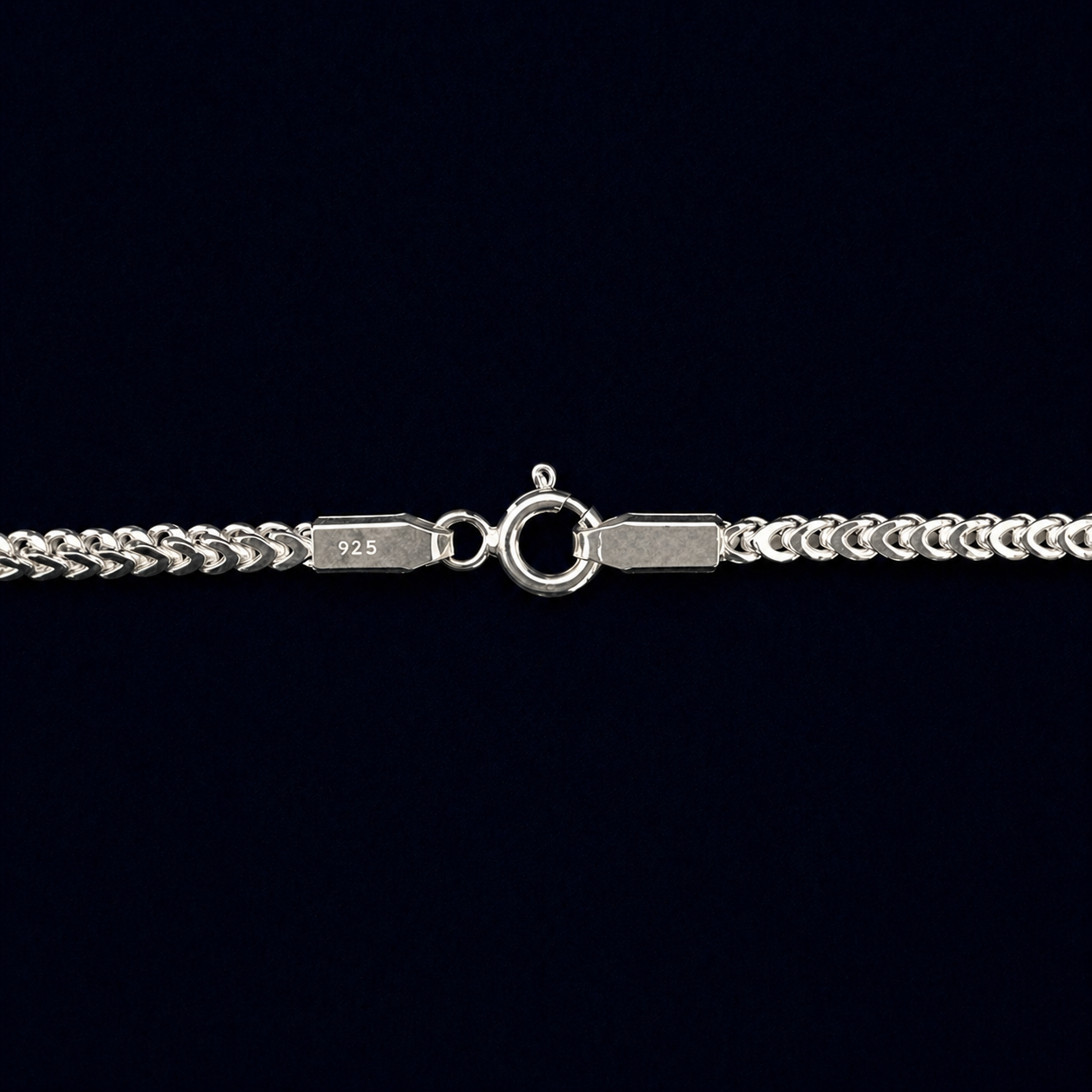Macro close-up of the Infinite Link necklace showcasing the secure lobster clasp and clear 925 authenticity hallmarks on the polished interlocking silver links.