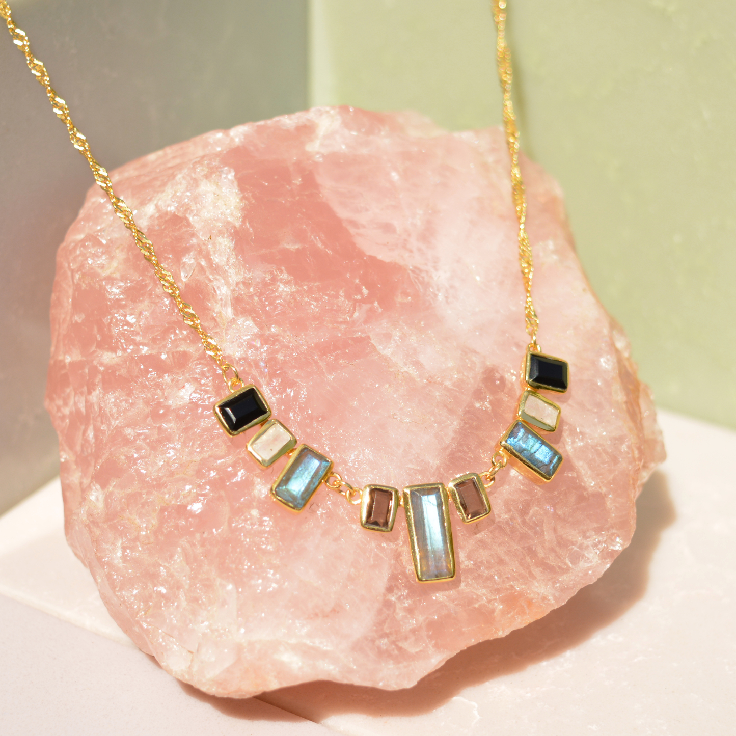 Close-up perspective of the A Story of Stones necklace, showcasing the iridescent blue flashes of the labradorite and the warm earthy tones of the smoky quartz and moonstone links.
