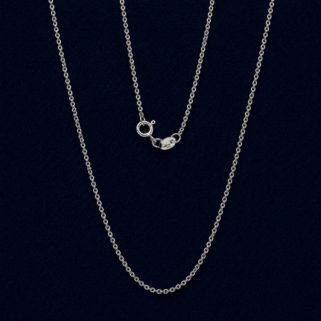 Elegant 925 sterling silver stackable necklace with a slim cable chain and modern hoop lock detail, displayed against a dark navy background.