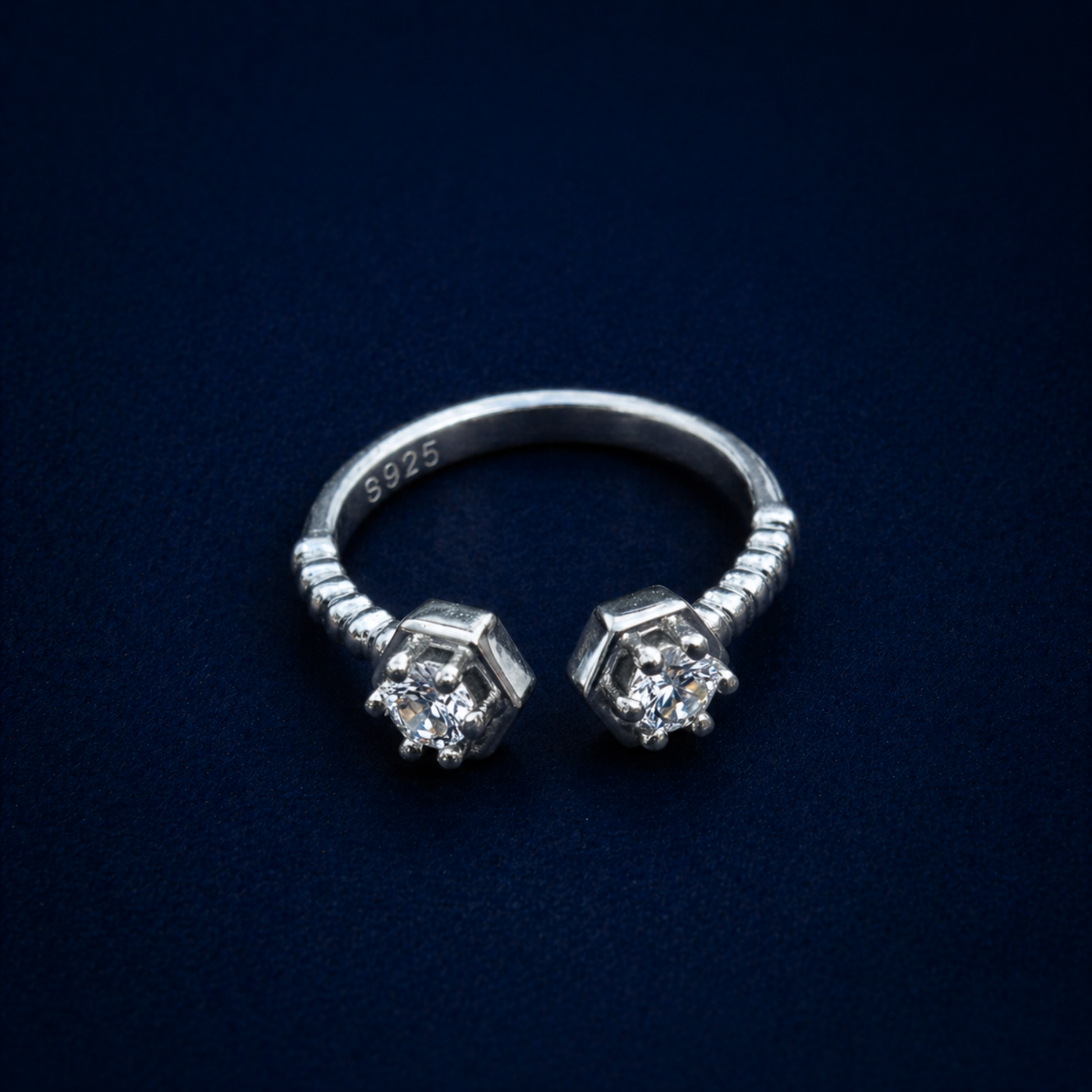 An angled perspective of the A Little Spark Ring, displaying the brilliant-cut cubic zirconia stones and the authentic S925 hallmark on the inner polished band.