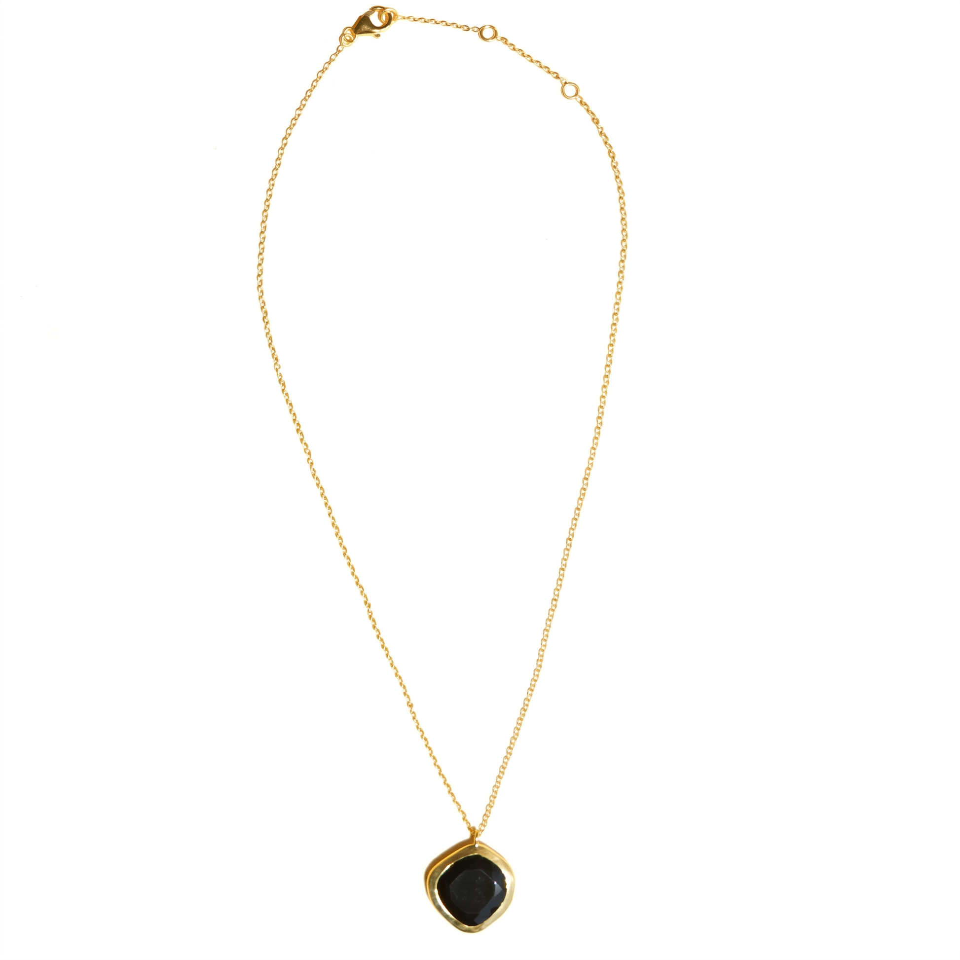 Full studio shot of the Bold Calm necklace on a white background, displaying the artisanal black onyx pendant and adjustable gold chain.