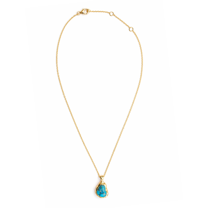 ull studio shot of the Earthy Charm necklace on a white background, displaying the artisanal copper turquoise pendant and the adjustable 18kt gold plated 925 sterling silver chain.