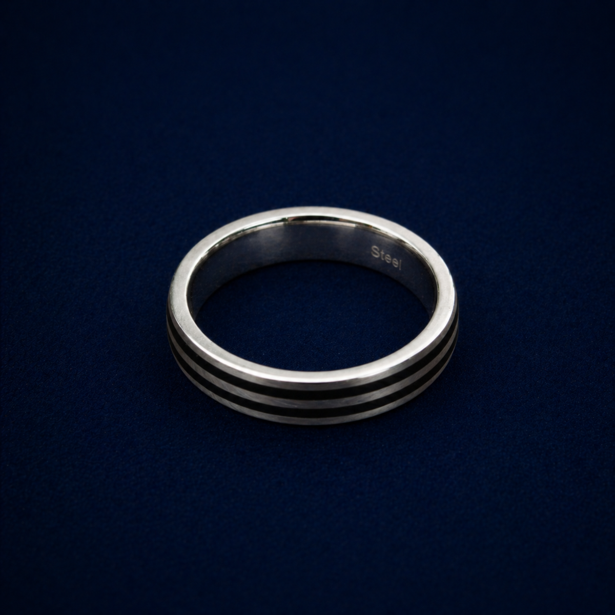 An angled shot of the Urban Lines Ring highlighting the two sleek black enamel parallel lines inlaid into a polished sterling silver band for a contemporary, urban look.
