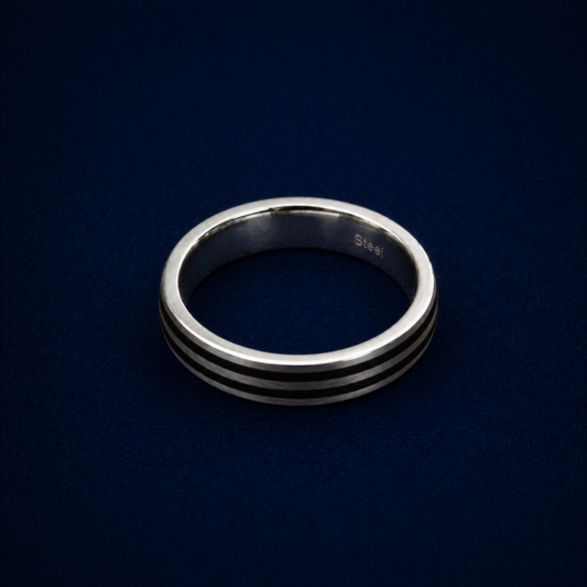 An angled shot of the Urban Lines Ring highlighting the two sleek black enamel parallel lines inlaid into a polished sterling silver band for a contemporary, urban look.