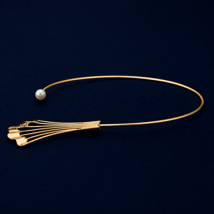A side perspective of the Soft Glow choker highlighting the sleek, flexible neck cuff design and the polished finish of the modern fan-shaped charm on a dark navy background.