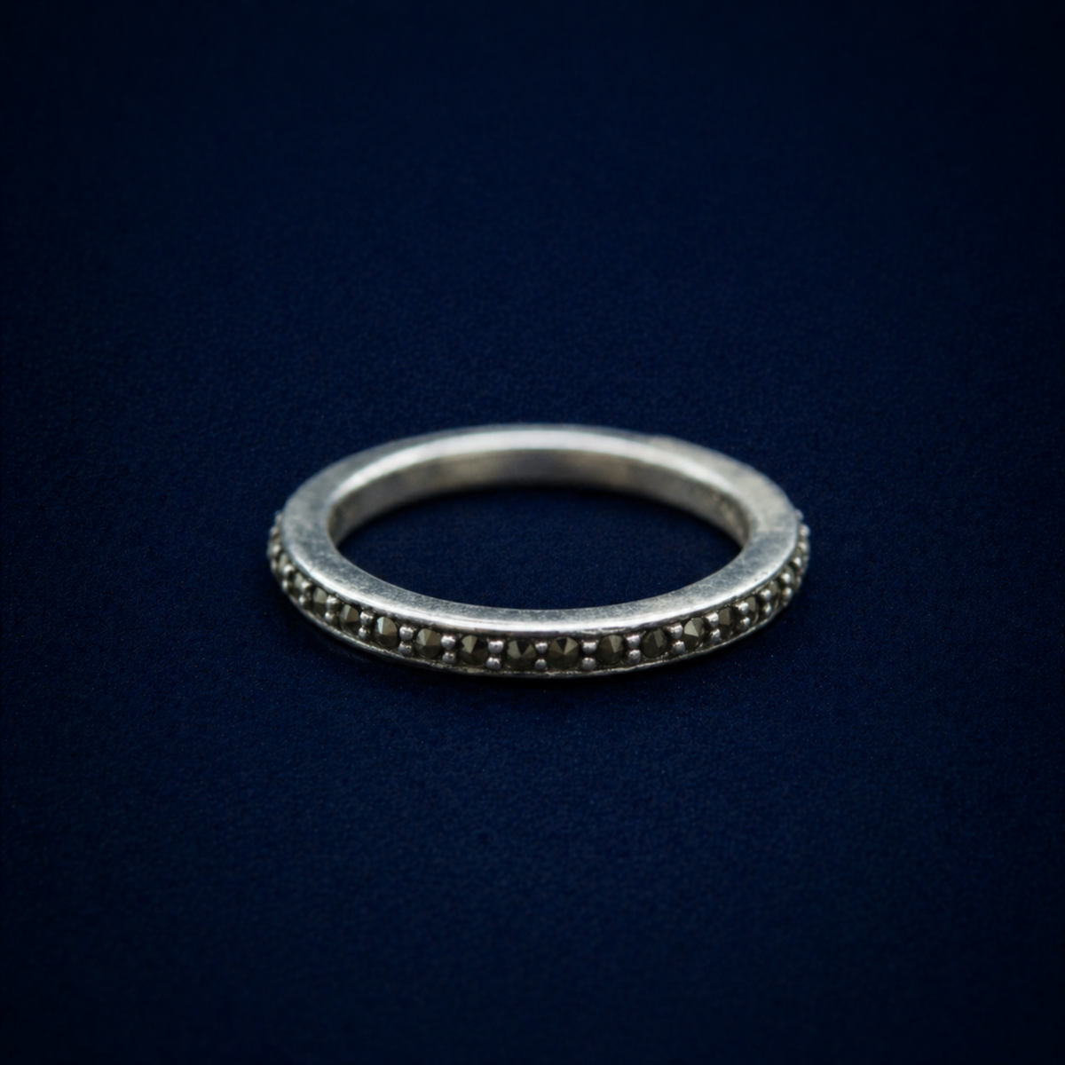 An angled perspective of the Everyday Sparkle Ring highlighting the continuous row of pavé-set tiny cubic zirconia stones and the subtle vintage-style oxidized silver finish.