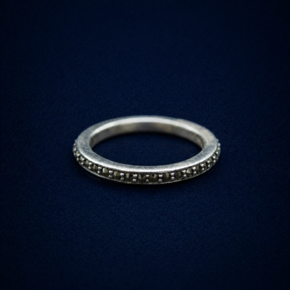 An angled perspective of the Everyday Sparkle Ring highlighting the continuous row of pavé-set tiny cubic zirconia stones and the subtle vintage-style oxidized silver finish.