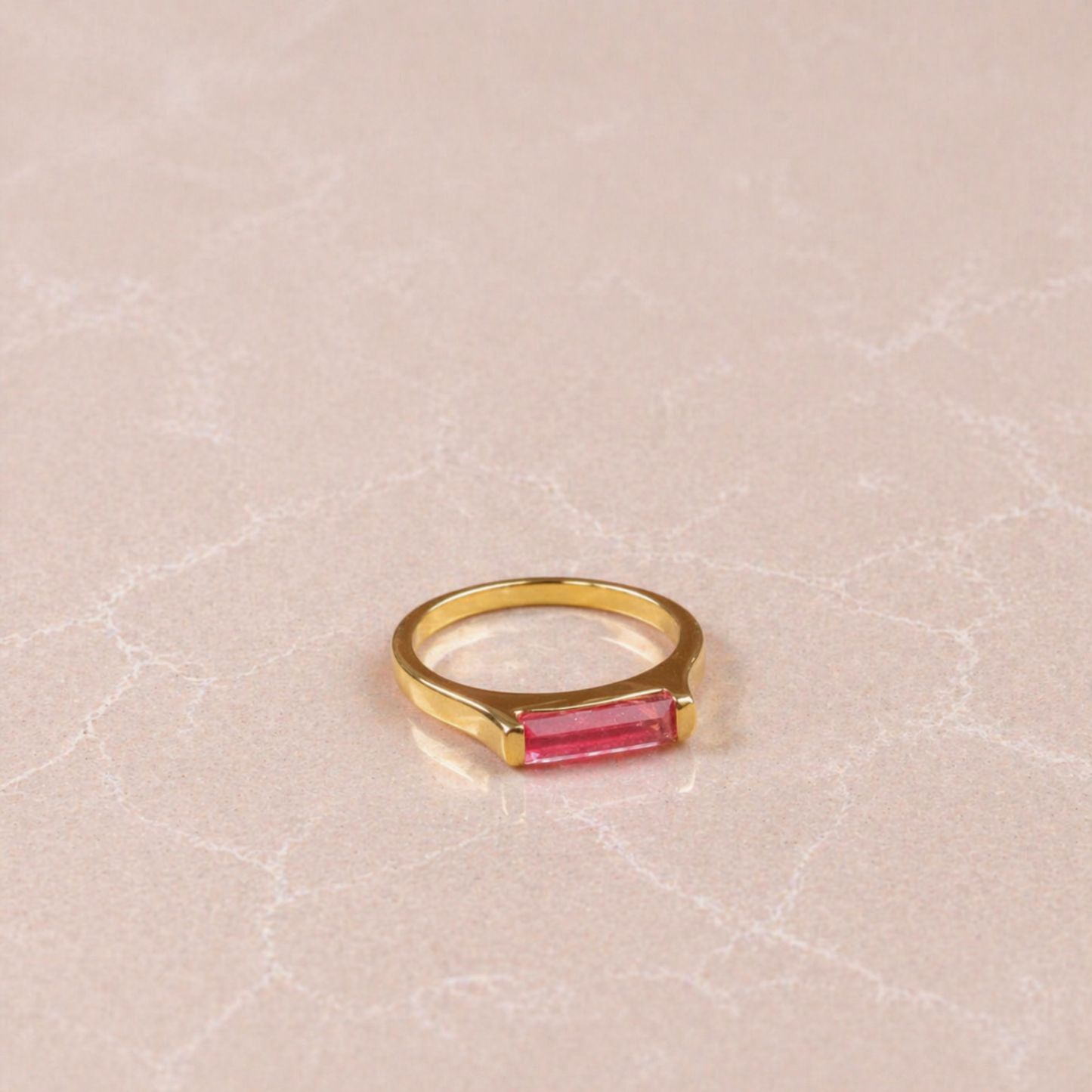 Side perspective of the handcrafted Blush Glow Ring showing the modern structured setting and the polished gold finish that complements the soft pink jade stone.
