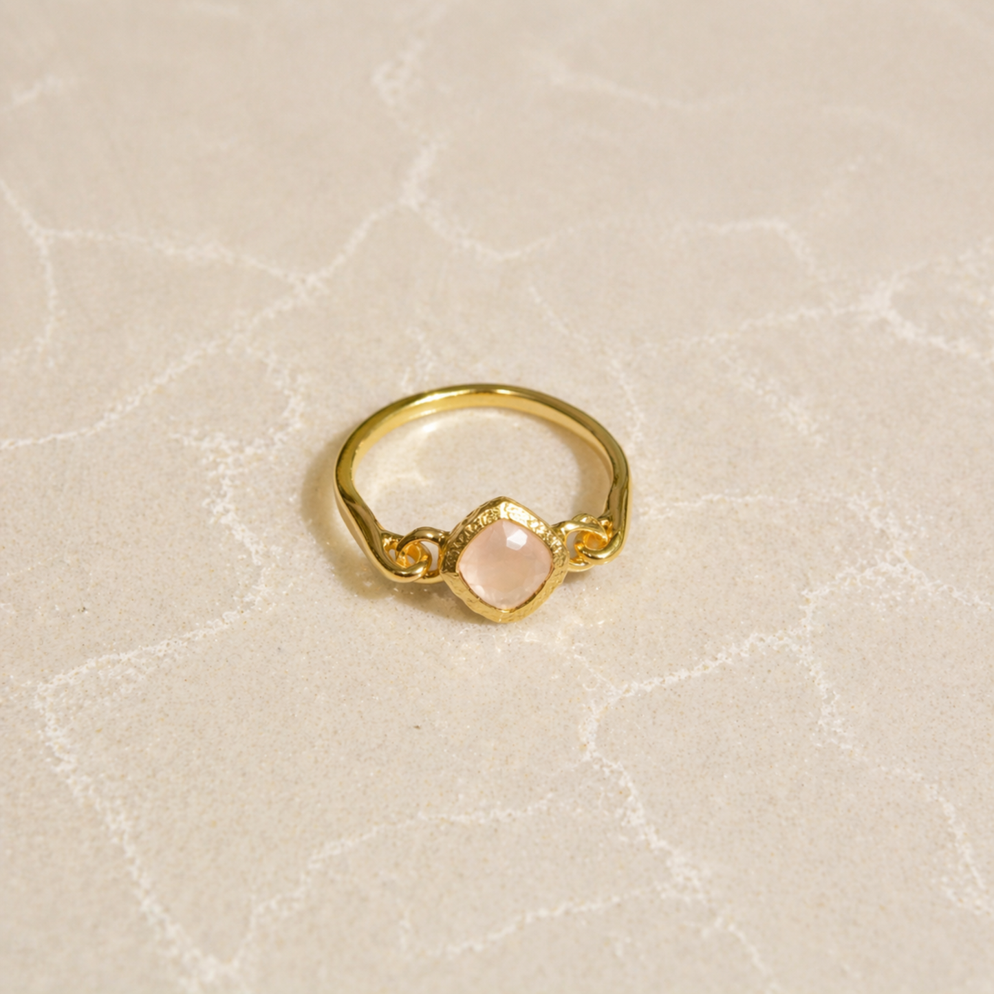 Blush Glow Ring on a neutral textured background, highlighting the square diamond-shaped rose quartz and modern minimal design.