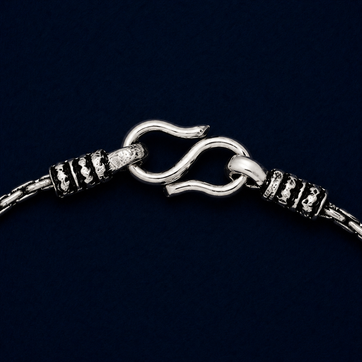 A detailed close-up of the Rhythm Bar anklet highlighting the rhythmic bar texture of the 925 silver links and the artisanal oxidized detailing near the secure S-hook closure.