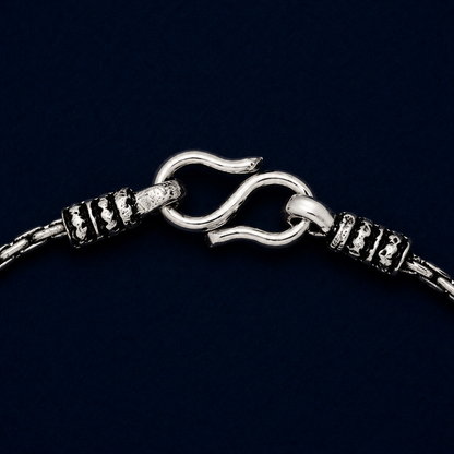 A detailed close-up of the Rhythm Bar anklet highlighting the rhythmic bar texture of the 925 silver links and the artisanal oxidized detailing near the secure S-hook closure.