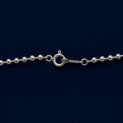 A detailed close-up of the Subtle Minimal Shine necklace highlighting the polished finish of the small silver beads and the secure spring ring closure.