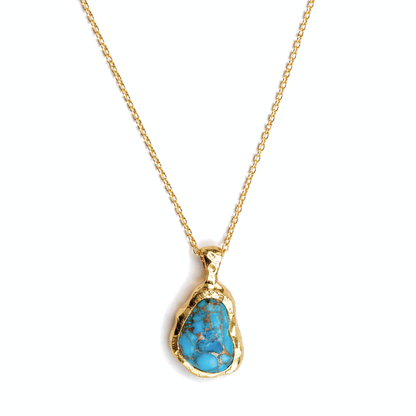 Close-up of the Earthy Charm pendant highlighting the vibrant blue and copper matrix of the irregular oval turquoise stone set in a polished 18kt gold plated frame.