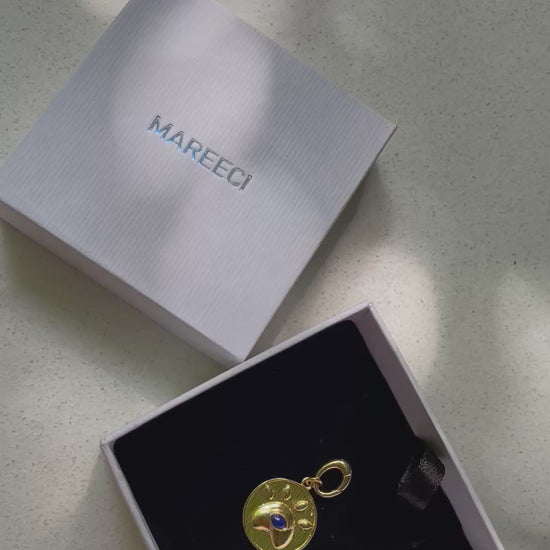 Eye of Love gold-tone charm with lapis lazuli in paw-inspired heart frame