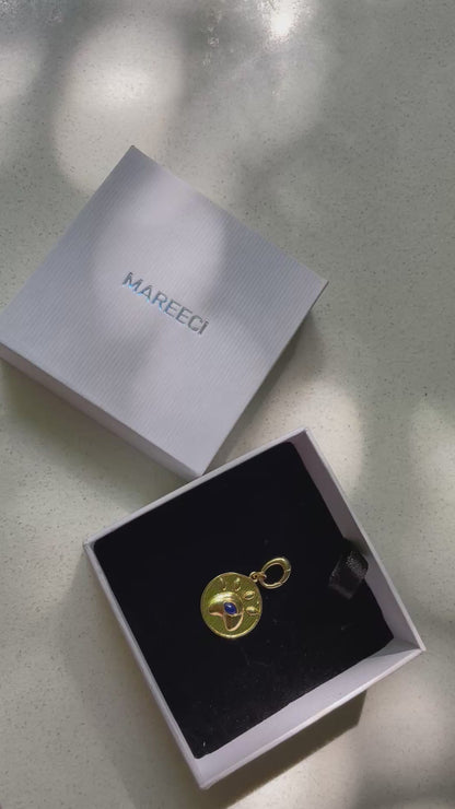 Eye of Love gold-tone charm with lapis lazuli in paw-inspired heart frame