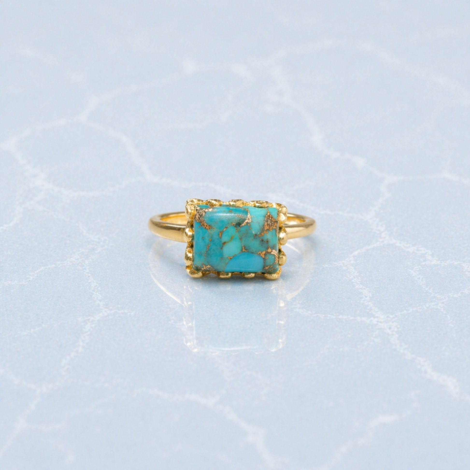 Frontal view of the Earthy Charm Ring showcasing the natural gold-toned matrix patterns in the turquoise stone and the polished minimal gold setting.