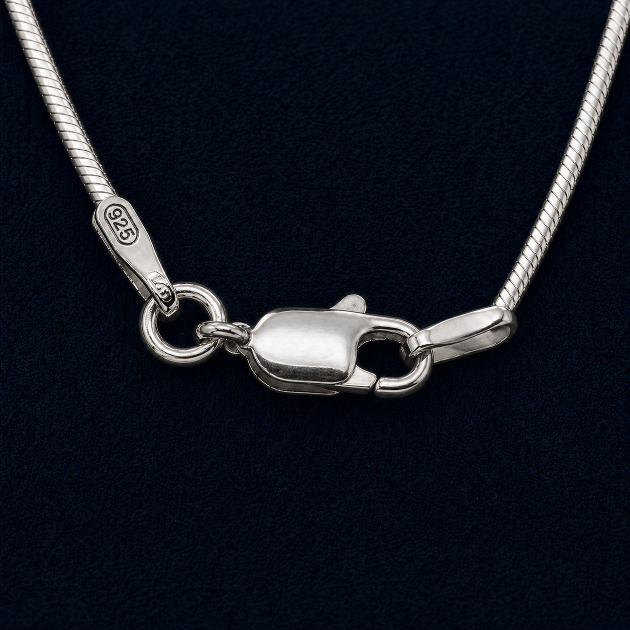 A long Round Drift snake chain in pure 925 sterling silver, displayed in an elegant vertical arrangement to highlight its fluid, mirror-like polished finish.