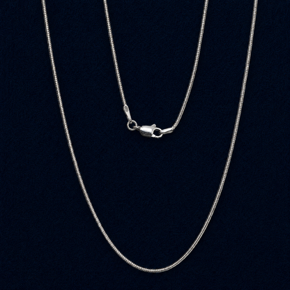 Macro view of a handcrafted 925 sterling silver snake chain necklace, featuring a high-shine lobster clasp and clear 925 authenticity hallmark against a dark navy background.