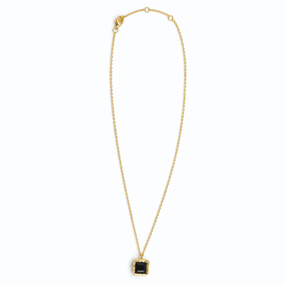 Full studio shot of the Bold Simplicity necklace on a white background, featuring a geometric square black onyx stone and a polished 18kt gold plated 925 sterling silver chain.