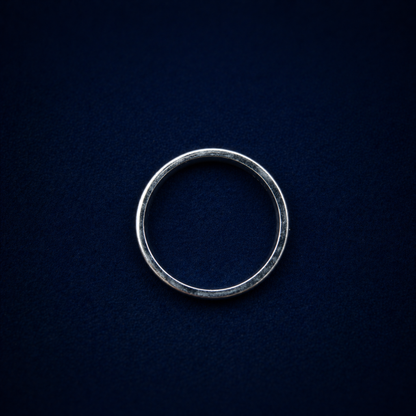 A top-down view of the handcrafted Urban Lines Ring on a dark navy background, showcasing the perfect circular silhouette of the 925 sterling silver band.