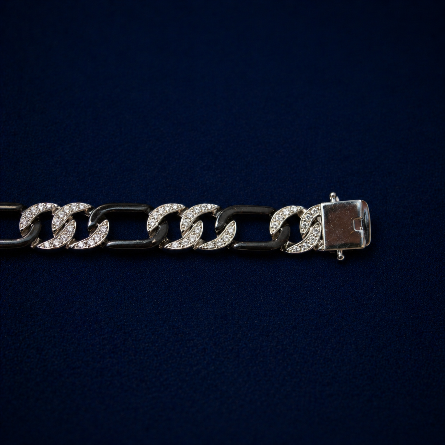 An angled perspective of the Effortless Edge bracelet showcasing the alternating pattern of stone-encrusted and polished black rhodium links for a bold, urban aesthetic.