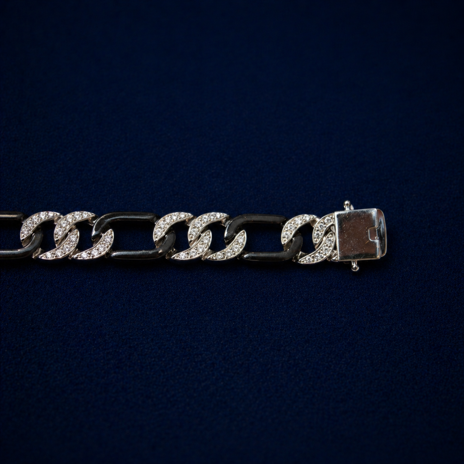 An angled perspective of the Effortless Edge bracelet showcasing the alternating pattern of stone-encrusted and polished black rhodium links for a bold, urban aesthetic.