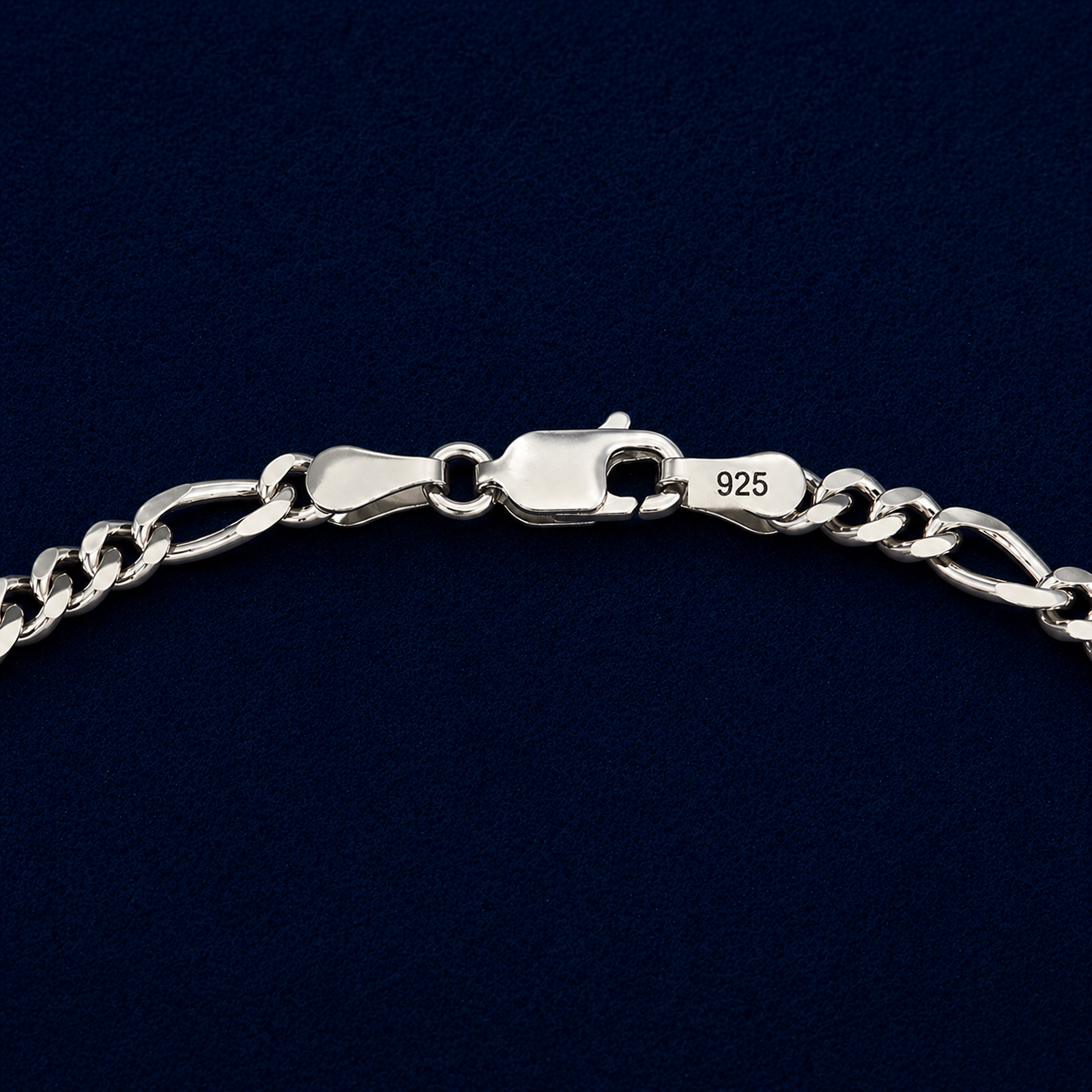 Macro shot of a handcrafted 925 sterling silver Urban Twist necklace showing the high-shine lobster clasp and intricate twisted paperclip links against a dark navy background.