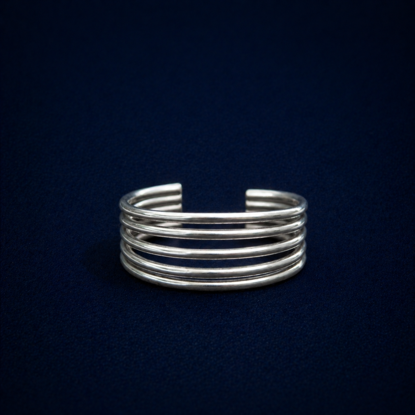 Frontal view of A Little Statement Ring showcasing the parallel multi-wire structure and polished finish of the wide sterling silver band.