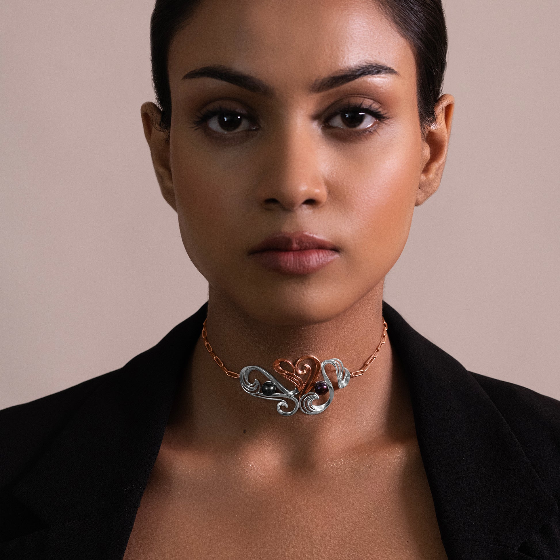 Portrait view of a stylish silver choker, showcasing its modern, fluid design and how it elegantly complements a formal or evening neckline.