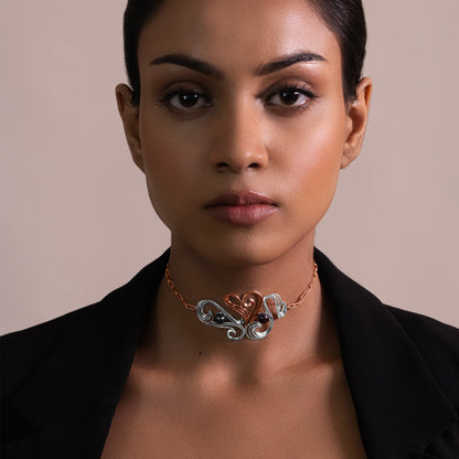 Portrait view of a stylish silver choker, showcasing its modern, fluid design and how it elegantly complements a formal or evening neckline.