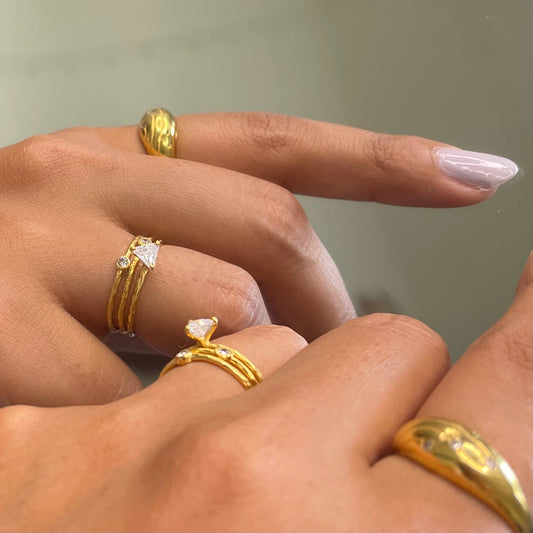 Angled view of minimalist rings stacked together for an elegant, modern aesthetic.