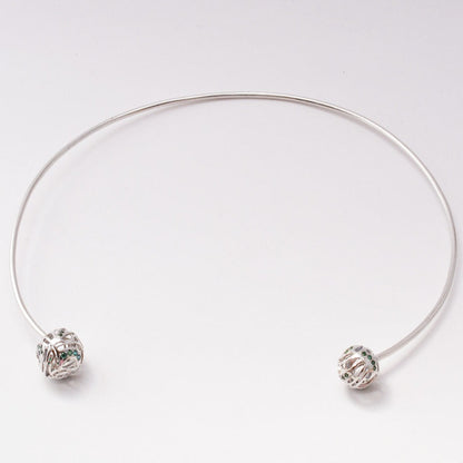 A contemporary brass choker featuring a bold, sculptural, wave-inspired design with a high-shine, polished finish, isolated on a white background.